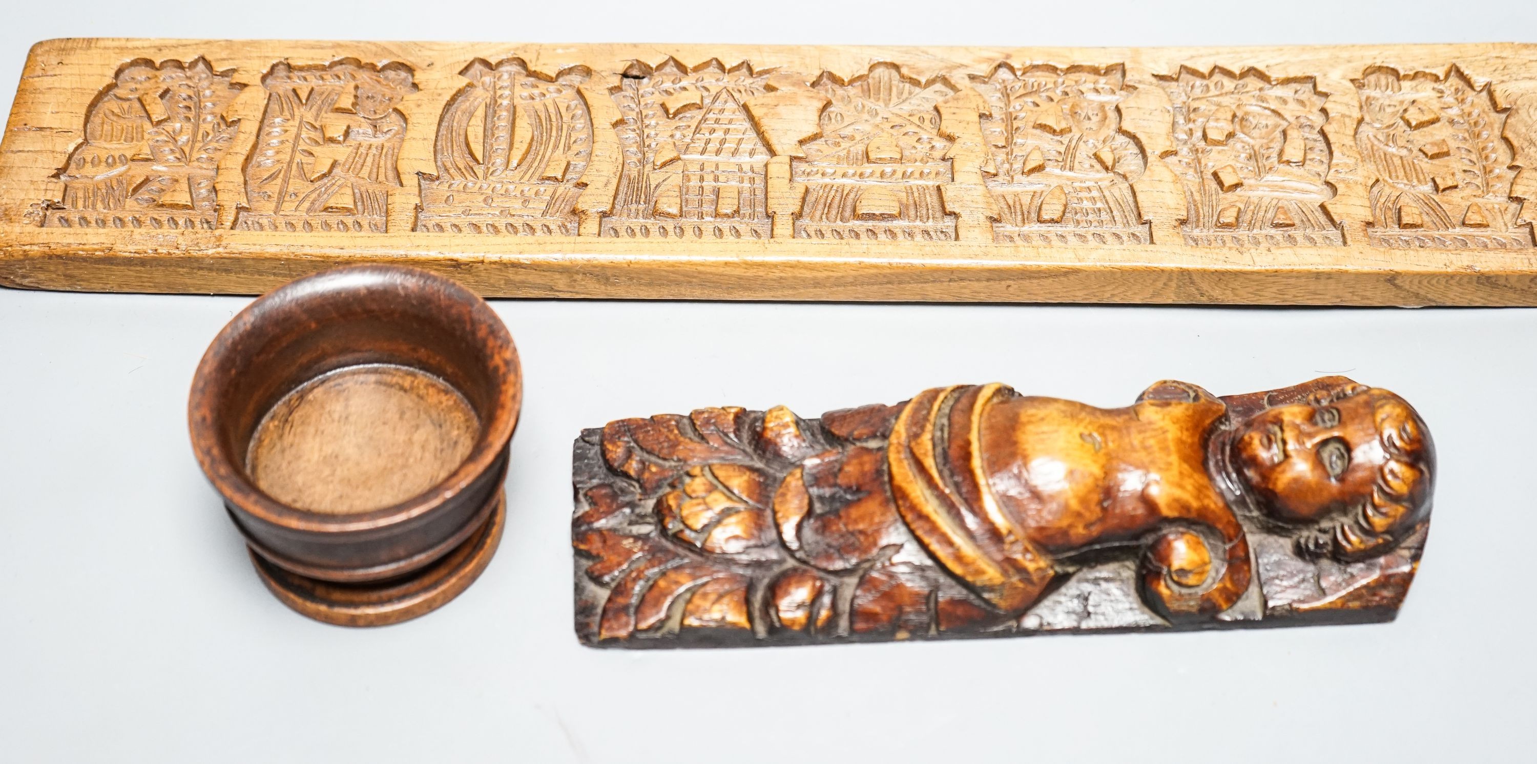 A 17th century carved oak caryatid terminal figure and two treen items 53cm